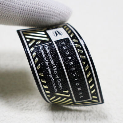 कस्टम टीपीयू हाई-फ्रीक्वेंसी पैच - मेटैलिक गोल्ड और ब्लैक प्रोफेशनल प्लेयर सीरीज़ बैज स्पोर्ट्सवियर के लिए